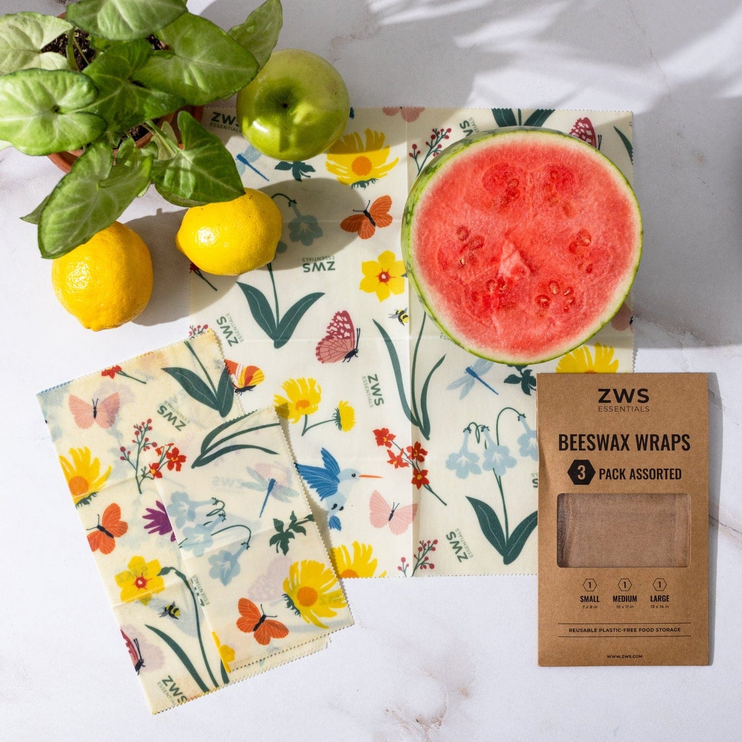 Set of three assorted beeswax wraps from ZeroWasteStore.com, plastic-free food storage wraps with floral and pollinator patterns.