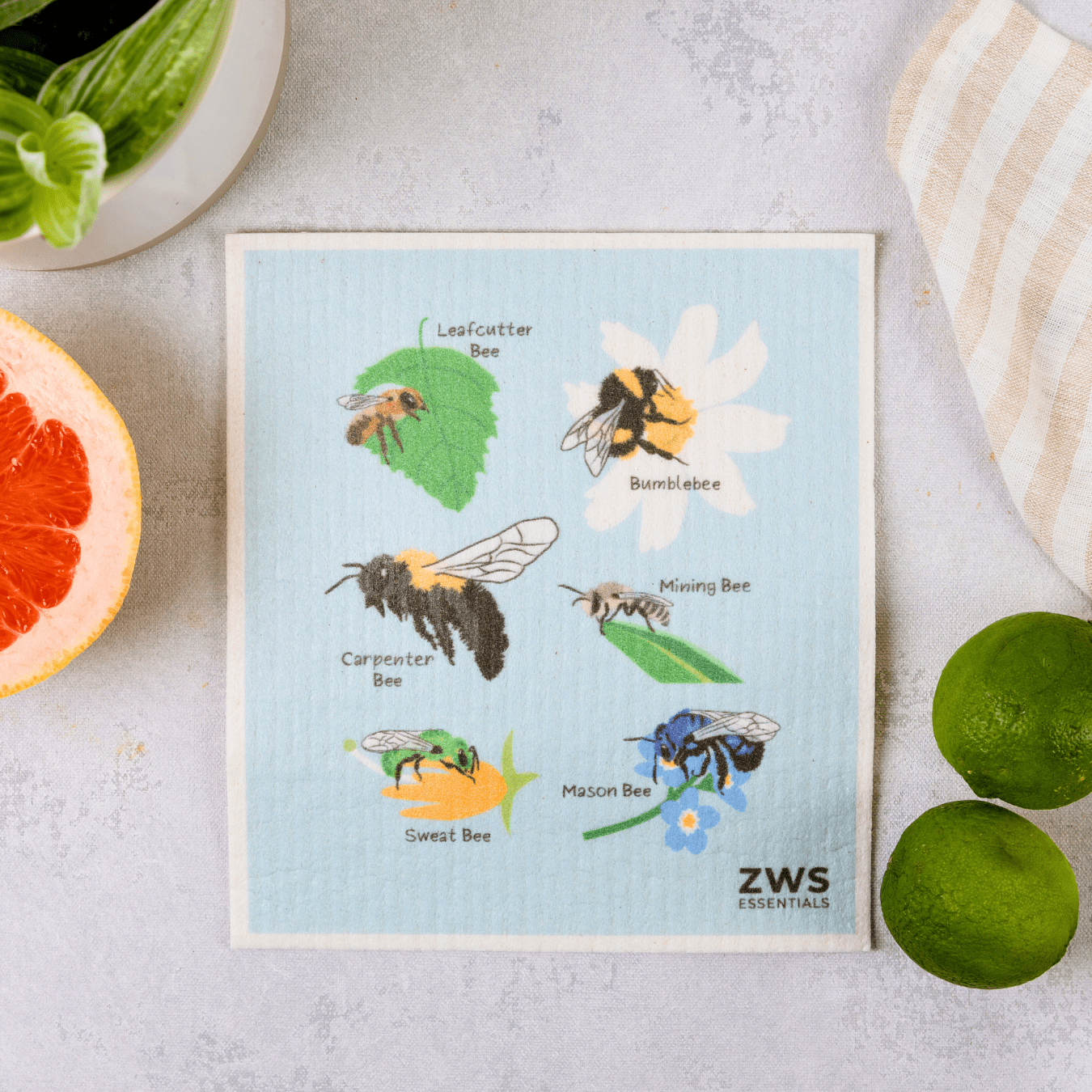 The Swedish Dish Cloth by ZeroWasteStore.com showcases vibrant illustrations of six labeled bees—Leafcutter, Bumblebee, Carpenter, Mining, Sweat, and Mason—surrounded by fruits and herbs. An eco-friendly alternative to paper towels!.